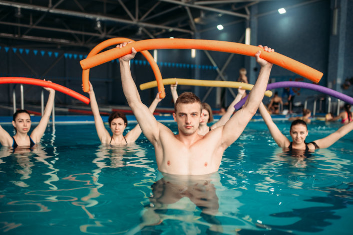Instructor and class on workout in swimming pool